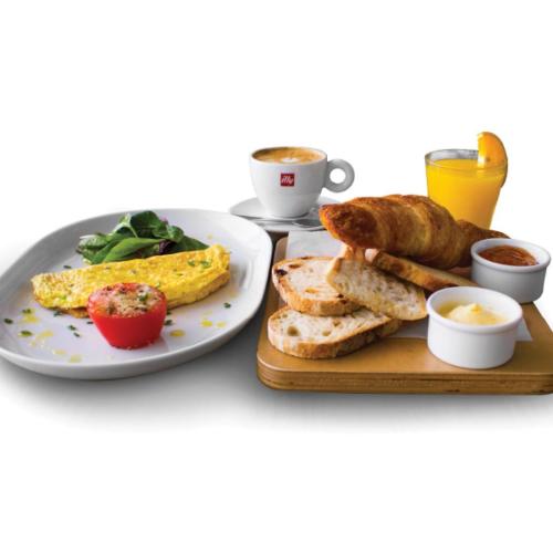 a plate of breakfast food with toast and a cup of coffee at Villa Pirreca in Favignana