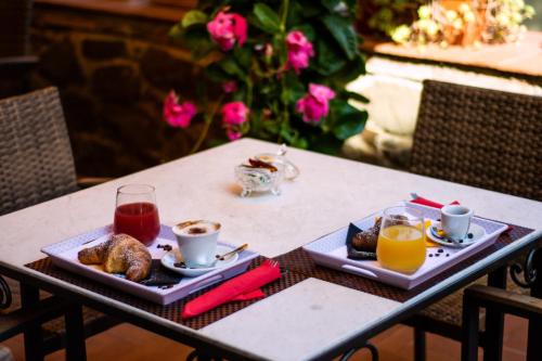 a table with two plates of breakfast foods and drinks at Agriturismo La Camporena in Greve in Chianti