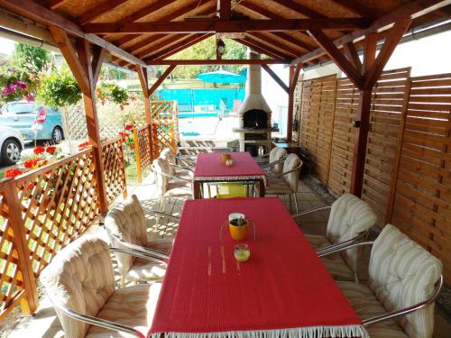 a red table and chairs on a patio at Penzion Aida Ostrava in Ostrava