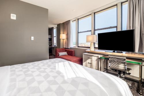 a hotel room with a bed and a flat screen tv at Holiday Inn Columbia - Downtown by IHG in Columbia