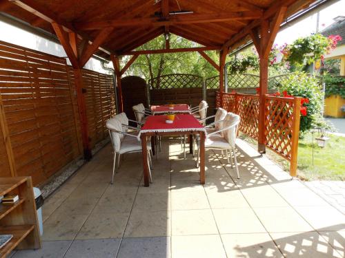 a wooden pergola with a table and chairs on a patio at Penzion Aida Ostrava in Ostrava