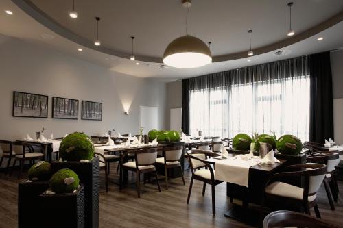 a restaurant with tables and chairs and a large window at Konsum Berghotel Oberhof in Oberhof