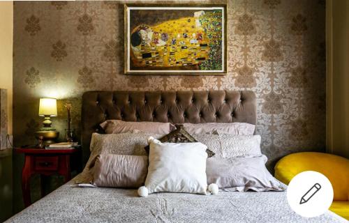 a bedroom with a bed with a painting on the wall at Edifício Andressa in Florianópolis