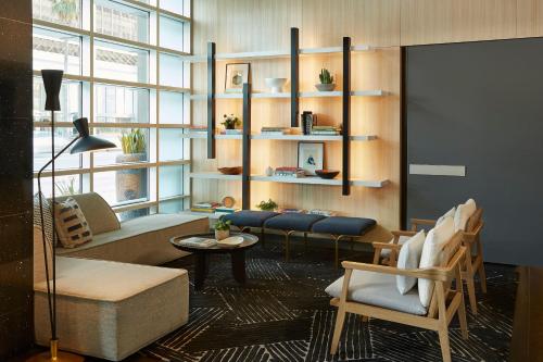 a living room with a couch and a table at Kimpton Hotel Wilshire by IHG in Los Angeles