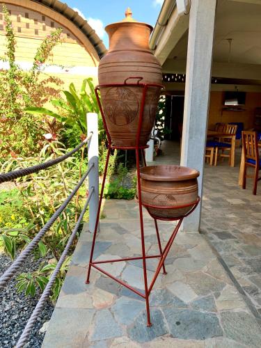 a large vase on a stand on a patio at Hôtel Amédzépé in Palimé
