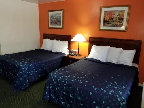 a hotel room with two beds and a telephone at Norvic Motel in Coniston