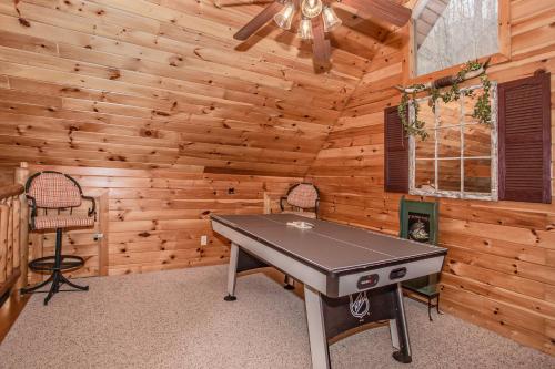 a dining room with a ping pong table in a cabin at Alpine Joy-Hot Tub, Pond Access ,Cozy Cabin Retreat in the Smokies in Townsend