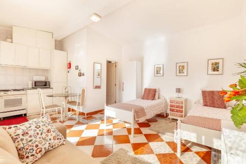 a living room with a couch and a table at Casa do Riacho in Esposende