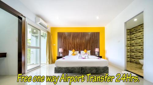 a bedroom with a large white bed in a room at Naiyang Place - Phuket Airport in Nai Yang Beach