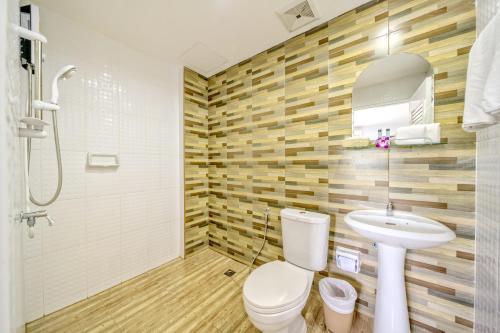 a bathroom with a toilet and a sink at Naiyang Place - Phuket Airport in Nai Yang Beach