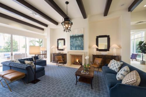 a living room with blue couches and a fireplace at The Inn by Sea Island in Saint Simons Island