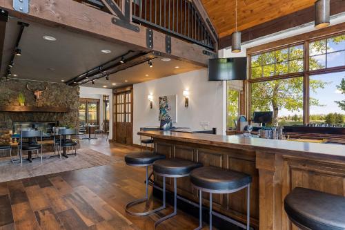 a bar in a home with wooden floors and windows at The Lodge at Bronze Buffalo Ranch in Victor
