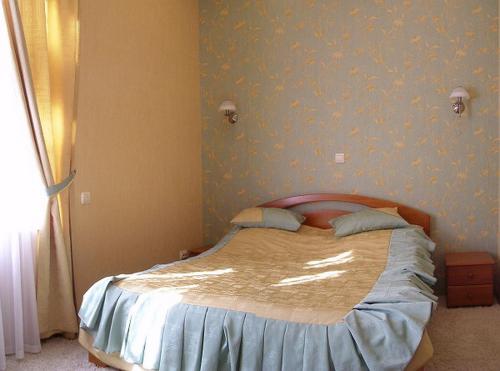 a bedroom with a bed with blue wallpaper at Park Apartment in Lviv