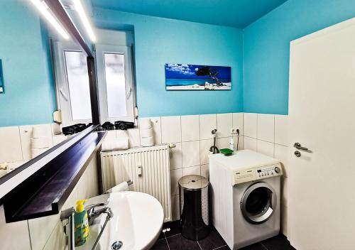 a bathroom with a washing machine and a sink at spacious studio - city centre - airconditioned - netflix - terrace in Heidelberg