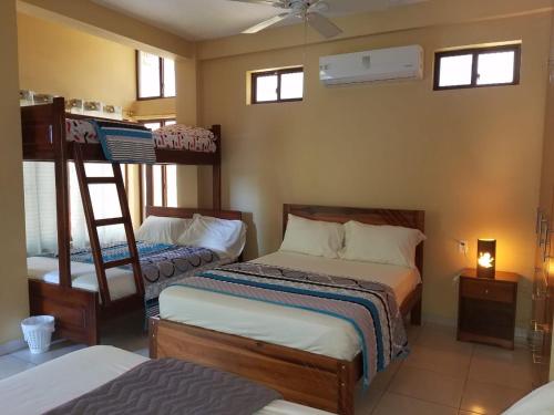 a bedroom with two bunk beds and a ladder at Hotel Soberao in Esmeraldas