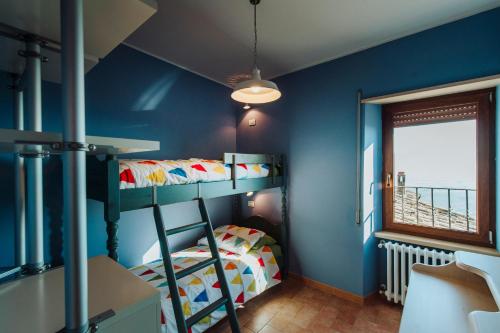 a bedroom with two bunk beds and a window at La casa di Gioia in Castiglione in Teverina