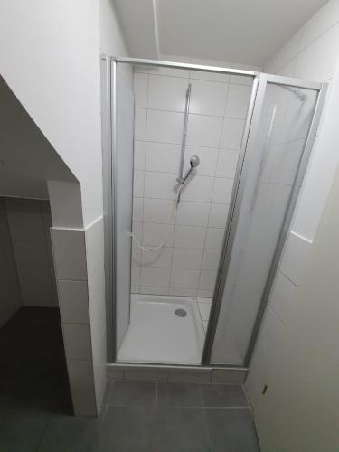 a shower with a glass door in a bathroom at White Pearl Hostel 2 in Nürnberg