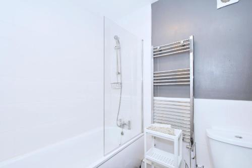 a white bathroom with a shower and a toilet at Townhouse @ Hanley Road Stoke in Ford Green