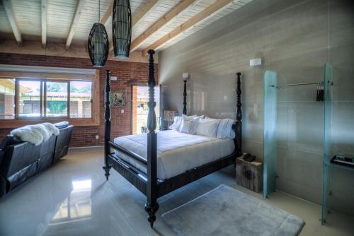 a bedroom with a four poster bed and a shower at Hotel Boutique Matea in Ixtapan de la Sal