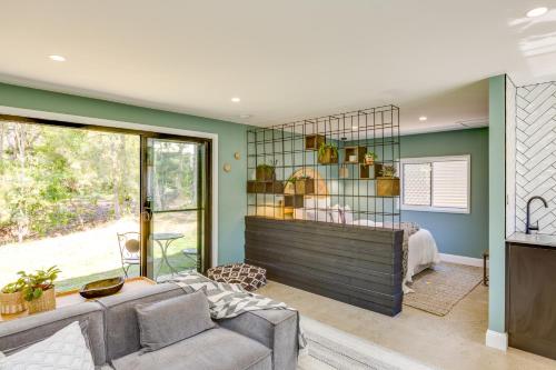 a living room with a couch and a window at Gorgeous Beachside Cottage Jervis Bay in Vincentia