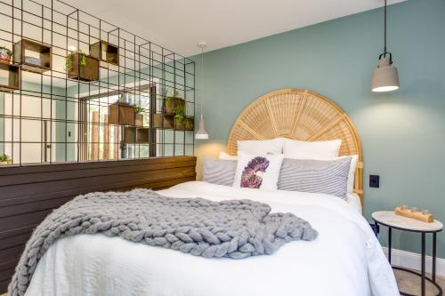 a bedroom with a large bed with a wooden headboard at Gorgeous Beachside Cottage Jervis Bay in Vincentia