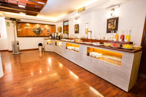 a kitchen with a counter with food on it at Conde de Lemos Hotel in Puno