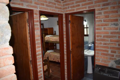 a room with two bunk beds and a sink at Cabañas La Rosada in Santa Rosa de Calamuchita