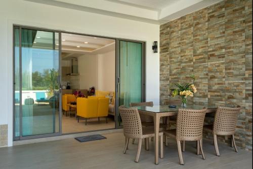 a dining room with a table and chairs at Private Villas Bangtao in Bang Tao Beach
