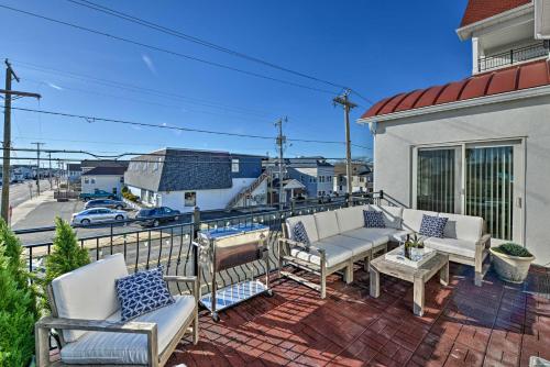 a patio with two chairs and a table on a balcony at Seaside Heights Beach Condo, Walk to Boardwlk in Seaside Heights