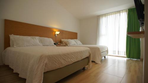 Cama o camas de una habitación en Hotel Bachue Girardot