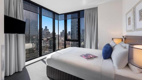 a hotel room with a bed and a large window at WRAP on Southbank in Melbourne