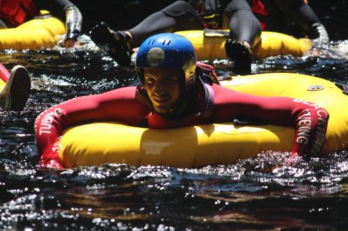 a man riding on an raft in the water at MALI Boutique Lodge & Tube 'n Axe Budget Accommodation in Stormsrivier