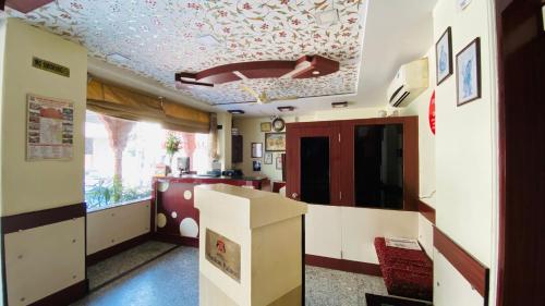 a kitchen with a ceiling decorated with flowers at Hotel Muskan Palace in Jaipur