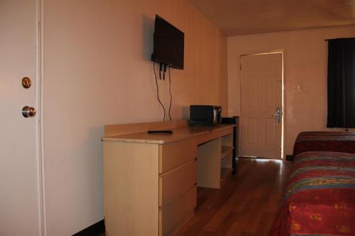 a hotel room with a desk and a bed at Sherman Inn in Sherman