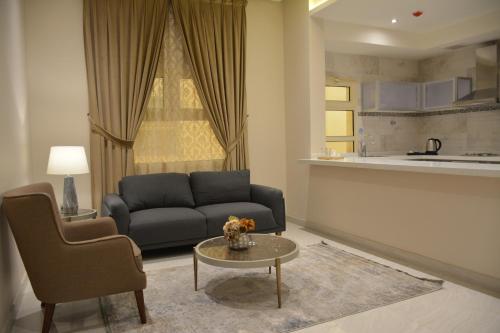 a living room with a couch and a table at Alshurfah Loft in Riyadh