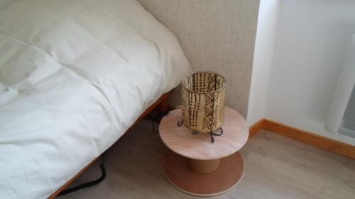 a bedroom with a bed and a table next to a bed at Chez Catherine et Roger in Brouvelieures