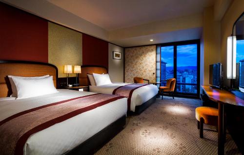 a hotel room with two beds and a balcony at RIHGA Royal Hotel Kyoto in Kyoto