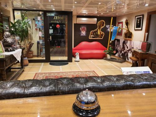 a leather couch in a store with a red seat at Hotel La Residencia in Cadaqués