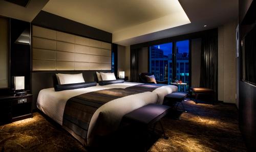 a bedroom with a large bed and a large window at RIHGA Royal Hotel Kyoto in Kyoto
