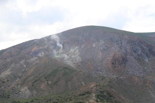 a mountain with smoke coming from the top of it at Guesthouse Oyado Iizaka in Fukushima