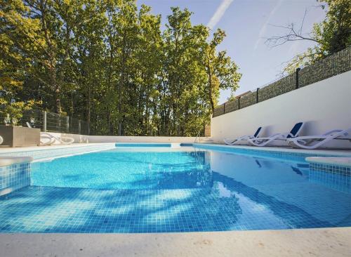 a swimming pool with blue water in a house at Luxury villa Luck in Imotski, private pool in Imotski