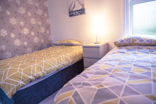 a bedroom with two beds and a window at NORTHRISE RETREAT in Hastings