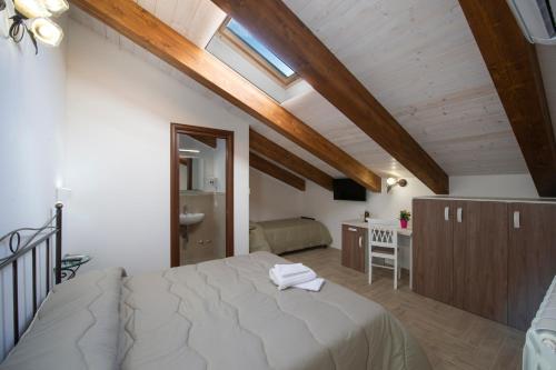 a bedroom with a large bed in a attic at Il Ritrovo degli dei in Agerola