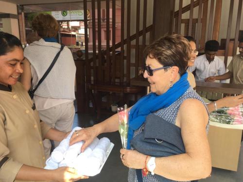 a woman is holding a bunch of towels at The Hotel Canoe in Kannur