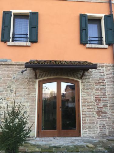 a front door of a building with green shutters at Ababo Affittacamere in Quattro Castella