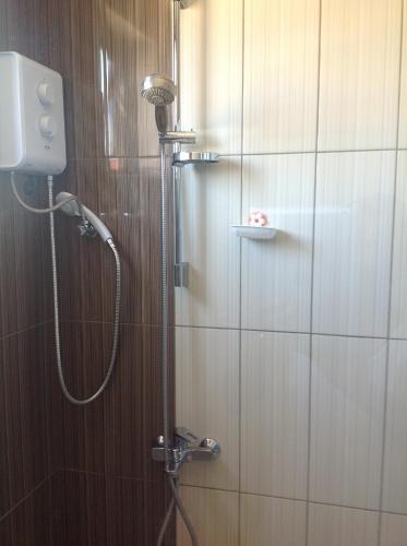 a shower with a shower head in a bathroom at Complexe Immobilier Avani 3 in Flic-en-Flac