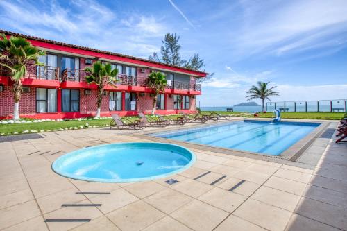 a resort with a swimming pool and a building at HANNA Búzios Al Mare Hotel in Búzios