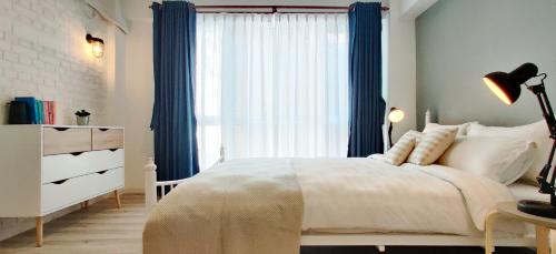 a bedroom with a white bed and a window at Ananya Apartments Phase 2 in Kathmandu