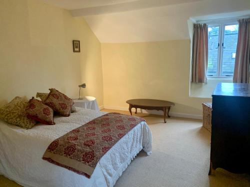 a bedroom with a bed and a table and a window at Bell Tower in Hereford
