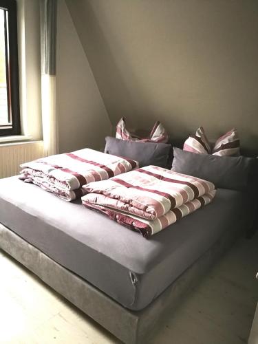 a bed with pillows on it in a room at Rosenblick in Zingst